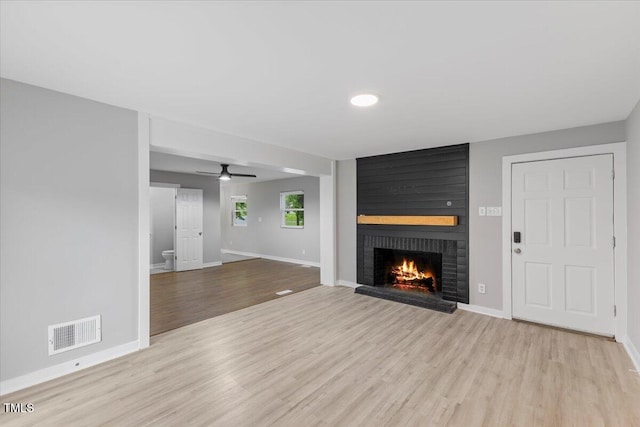 2752 Weldon Ter, Durham, NC 27703 - unfurnished living room with wood finished floors, a fireplace, baseboards, and a ceiling fan