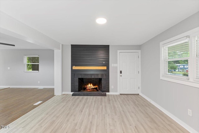 2752 Weldon Ter, Durham, NC 27703 - unfurnished living room with a fireplace, wood finished floors, and baseboards