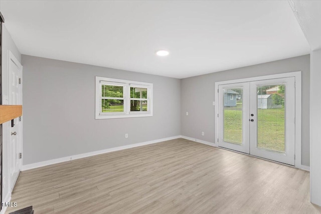 2752 Weldon Ter, Durham, NC 27703 - unfurnished living room with french doors, baseboards, and light wood finished floors