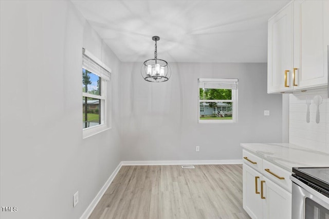 2752 Weldon Ter, Durham, NC 27703 - kitchen featuring a chandelier, light wood-style floors, and healthy amount of natural light