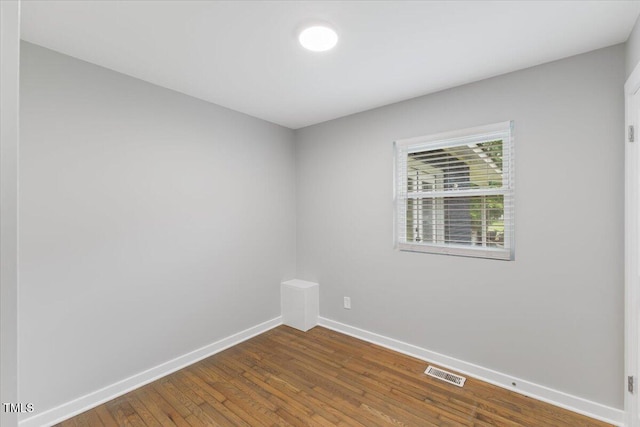 2752 Weldon Ter, Durham, NC 27703 - spare room with baseboards and dark wood-type flooring
