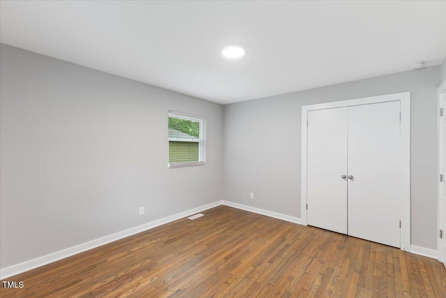 2752 Weldon Ter, Durham, NC 27703 - unfurnished bedroom with wood finished floors, baseboards, and a closet