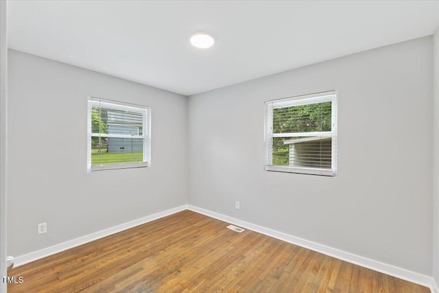2752 Weldon Ter, Durham, NC 27703 - spare room featuring plenty of natural light, baseboards, and wood finished floors