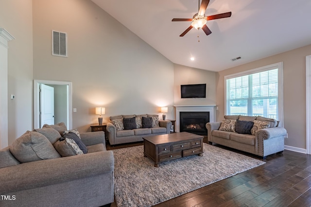 367 Tayside St, Clayton, NC 27520 - living area with dark wood-type flooring, ceiling fan, a glass covered fireplace, high vaulted ceiling, and baseboards