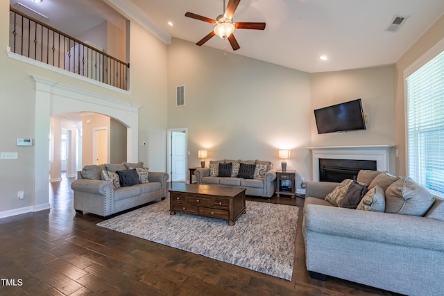 367 Tayside St, Clayton, NC 27520 - living room featuring arched walkways, a ceiling fan, a fireplace, dark wood-style floors, and baseboards