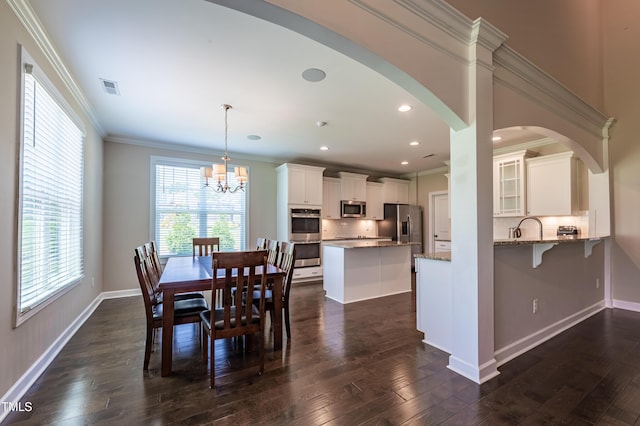 367 Tayside St, Clayton, NC 27520 - dining space with arched walkways, a chandelier, dark wood-style flooring, ornamental molding, and baseboards