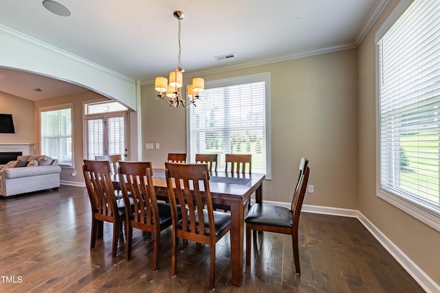 367 Tayside St, Clayton, NC 27520 - dining area featuring arched walkways, a chandelier, plenty of natural light, ornamental molding, and dark wood-style floors