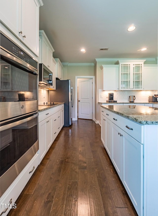 367 Tayside St, Clayton, NC 27520 - kitchen with stainless steel appliances, white cabinetry, light stone counters, backsplash, and ornamental molding