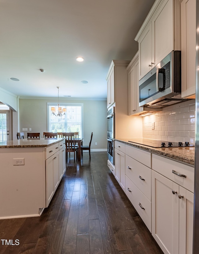367 Tayside St, Clayton, NC 27520 - kitchen with appliances with stainless steel finishes, healthy amount of natural light, decorative backsplash, dark wood finished floors, and ornamental molding