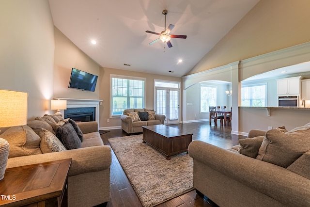 367 Tayside St, Clayton, NC 27520 - living room featuring arched walkways, ceiling fan, high vaulted ceiling, dark wood-style floors, and a glass covered fireplace