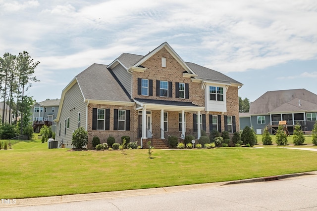 367 Tayside St, Clayton, NC 27520 - view of front of property with brick siding, covered porch, central AC unit, and a front yard