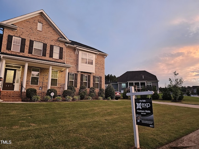 367 Tayside St, Clayton, NC 27520 - traditional-style house featuring brick siding, a lawn, and covered porch