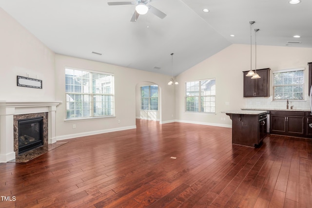 4110 Argyle Trl, Burlington, NC 27215 - kitchen featuring open floor plan, dark brown cabinets, a kitchen bar, vaulted ceiling, and a ceiling fan