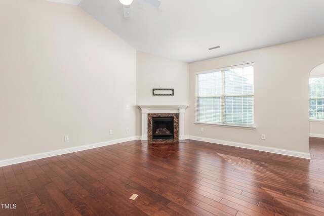 4110 Argyle Trl, Burlington, NC 27215 - unfurnished living room featuring dark wood-style flooring, a premium fireplace, vaulted ceiling, baseboards, and ceiling fan