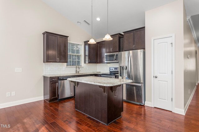 4110 Argyle Trl, Burlington, NC 27215 - kitchen featuring stainless steel appliances, dark brown cabinetry, dark wood finished floors, lofted ceiling, and recessed lighting