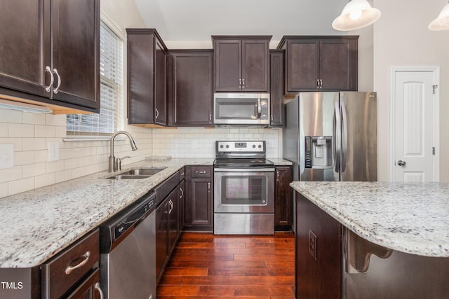 4110 Argyle Trl, Burlington, NC 27215 - kitchen with stainless steel appliances, a sink, dark wood-type flooring, and light stone countertops