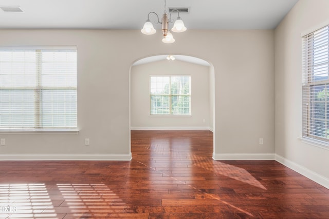 4110 Argyle Trl, Burlington, NC 27215 - unfurnished dining area featuring a chandelier, hardwood / wood-style floors, arched walkways, and healthy amount of natural light