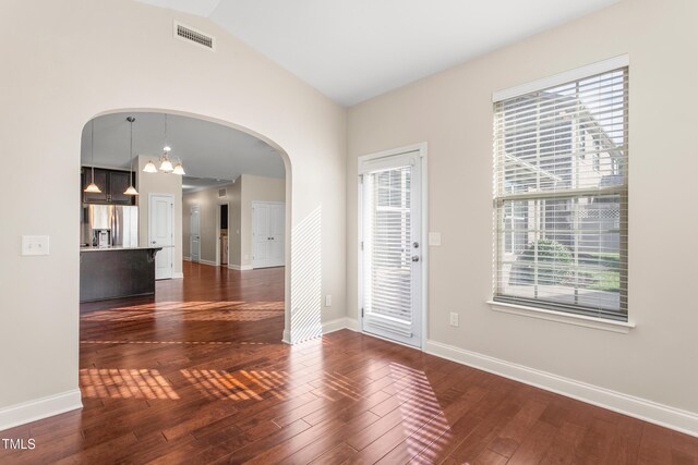 4110 Argyle Trl, Burlington, NC 27215 - foyer entrance with arched walkways, dark wood finished floors, vaulted ceiling, baseboards, and a chandelier