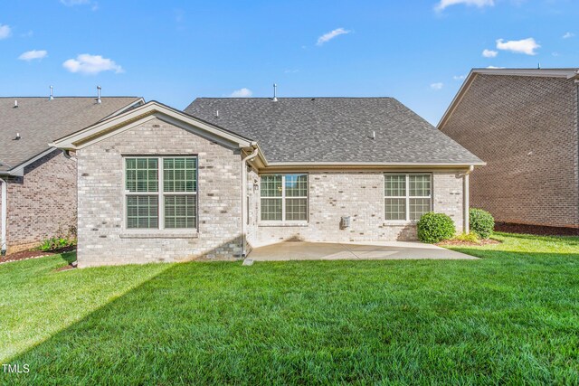 4110 Argyle Trl, Burlington, NC 27215 - back of property featuring a patio, brick siding, and a yard