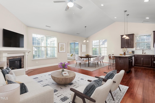 4110 Argyle Trl, Burlington, NC 27215 - living area with dark wood finished floors, a premium fireplace, a ceiling fan, baseboards, and high vaulted ceiling