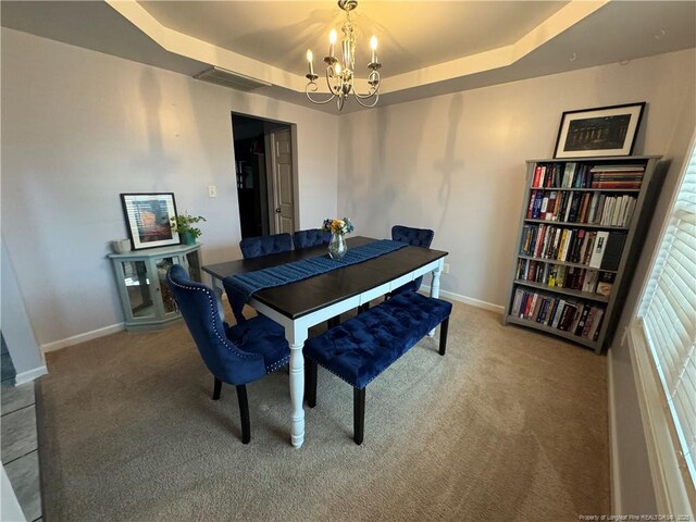 2108 Sir Michael Dr, Hope Mills, NC 28348 - dining room featuring a chandelier, carpet floors, a tray ceiling, and baseboards