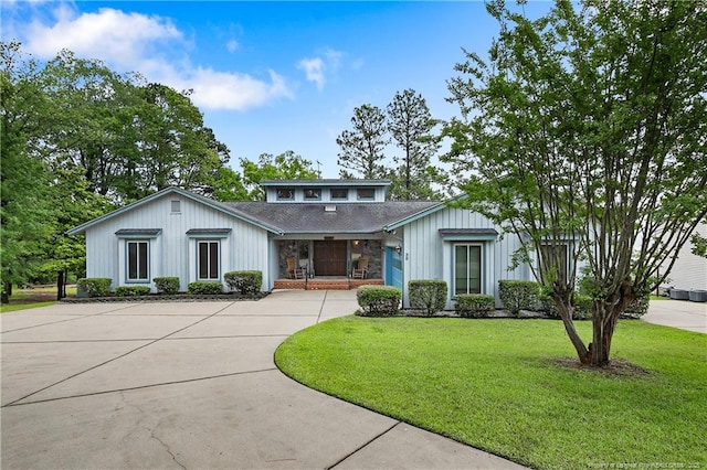38 E Lndg, Sanford, NC 27332 - view of front of house with curved driveway, a front lawn, stone siding, a garage, and board and batten siding