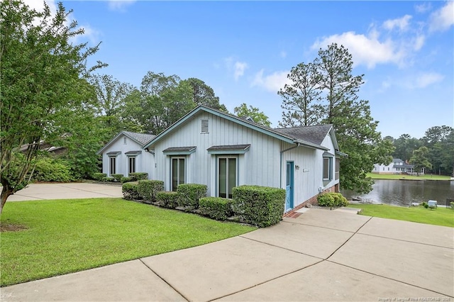 38 E Lndg, Sanford, NC 27332 - ranch-style home with a water view, a front lawn, and a shingled roof