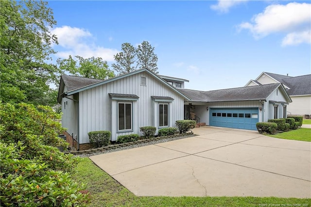 38 E Lndg, Sanford, NC 27332 - view of front of home featuring a garage, concrete driveway, board and batten siding, and a shingled roof