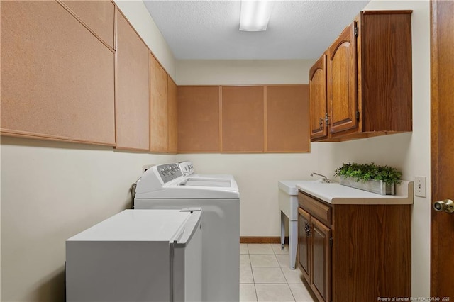 38 E Lndg, Sanford, NC 27332 - washroom with washer and clothes dryer, cabinet space, light tile patterned floors, and a textured ceiling