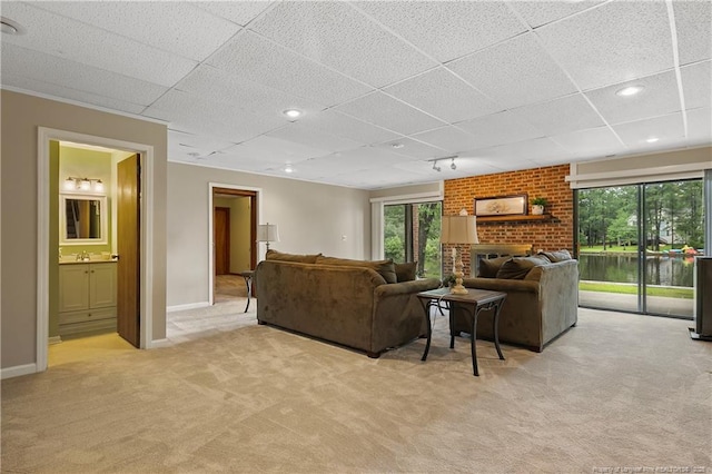 38 E Lndg, Sanford, NC 27332 - living room featuring light colored carpet, a paneled ceiling, and baseboards