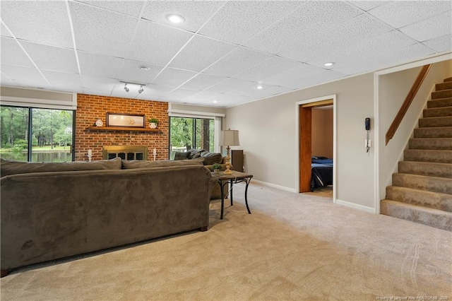 38 E Lndg, Sanford, NC 27332 - living area with light colored carpet, stairs, healthy amount of natural light, a brick fireplace, and a paneled ceiling