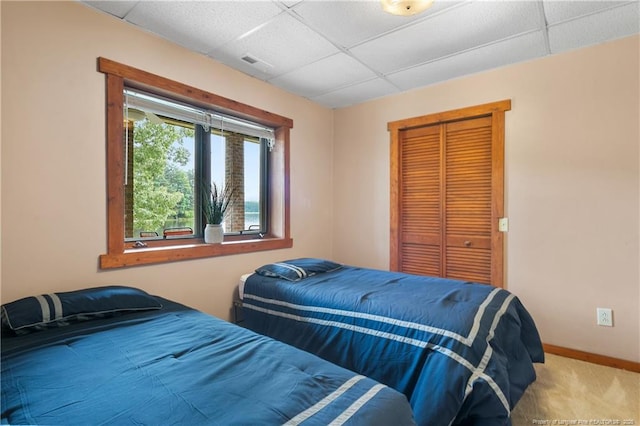 38 E Lndg, Sanford, NC 27332 - bedroom with a drop ceiling, baseboards, a closet, and carpet