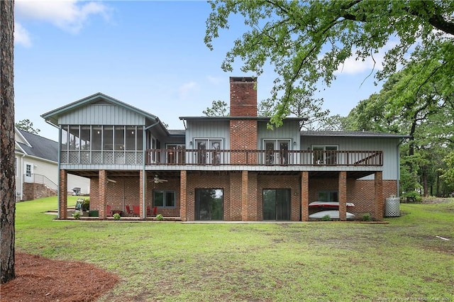 38 E Lndg, Sanford, NC 27332 - rear view of house featuring a deck, a chimney, a sunroom, and a yard