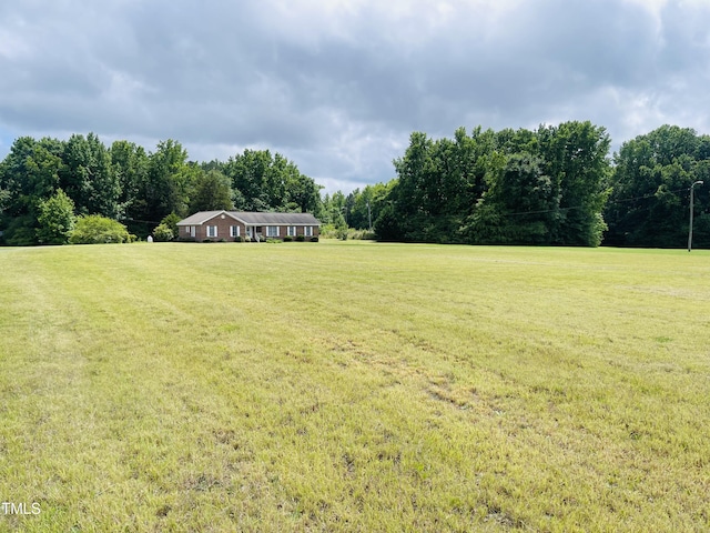 65 Opie Frazier Rd, Henderson, NC 27537 - view of grassy yard with a wooded view and a view of rural / pastoral area