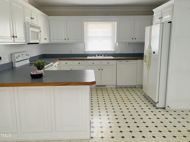 65 Opie Frazier Rd, Henderson, NC 27537 - kitchen with white appliances, a peninsula, a sink, dark countertops, and crown molding