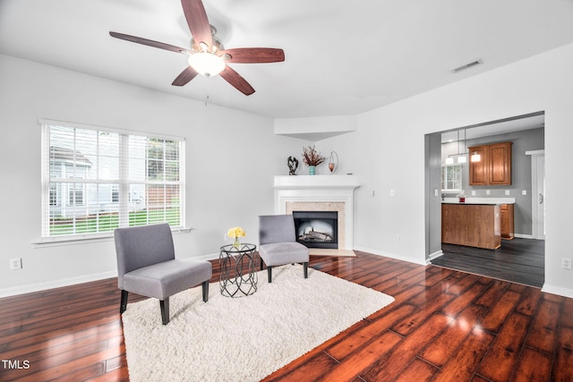 10941 Pendragon Pl, Raleigh, NC 27614 - living room featuring dark wood-type flooring, a high end fireplace, ceiling fan, and baseboards
