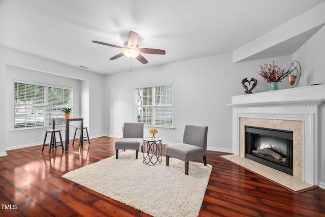 10941 Pendragon Pl, Raleigh, NC 27614 - living area featuring a ceiling fan, dark wood-type flooring, a fireplace, and baseboards