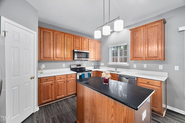 10941 Pendragon Pl, Raleigh, NC 27614 - kitchen with stainless steel appliances, a sink, dark wood-style flooring, and brown cabinets