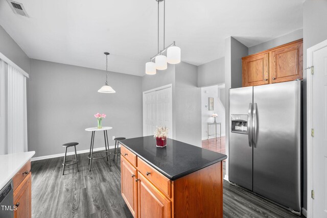 10941 Pendragon Pl, Raleigh, NC 27614 - kitchen with appliances with stainless steel finishes, dark wood-type flooring, brown cabinets, and a center island