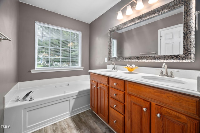 10941 Pendragon Pl, Raleigh, NC 27614 - bathroom featuring double vanity, wood finished floors, and a bath