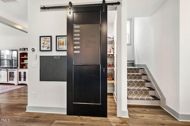 290 Quarter Gate Trce, Chapel Hill, NC 27516 - detailed view of wood finished floors, a barn door, and baseboards