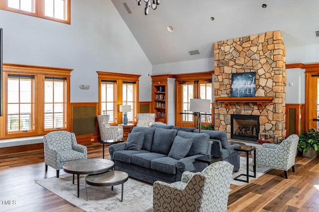 290 Quarter Gate Trce, Chapel Hill, NC 27516 - living area with high vaulted ceiling, a wainscoted wall, plenty of natural light, a stone fireplace, and wood-type flooring