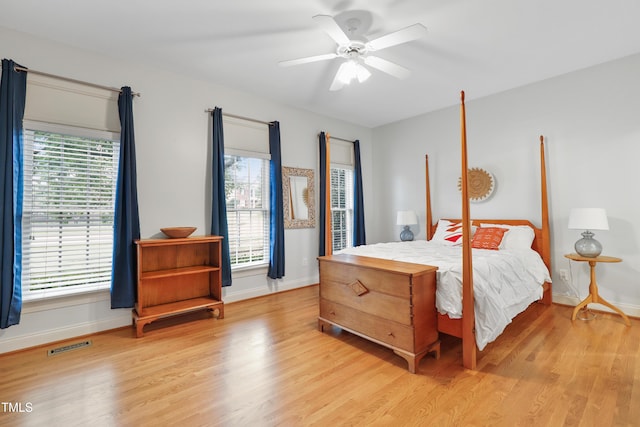 327 Commons Walk Cir, Cary, NC 27519 - bedroom with light wood finished floors, multiple windows, and baseboards