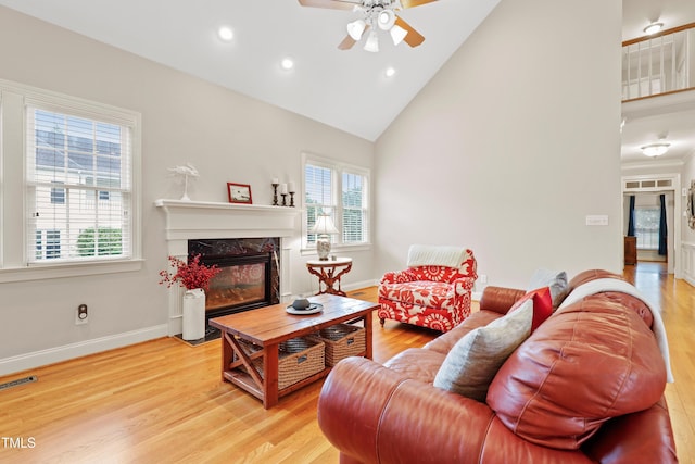 327 Commons Walk Cir, Cary, NC 27519 - living area with ceiling fan, plenty of natural light, a premium fireplace, light wood-style floors, and high vaulted ceiling