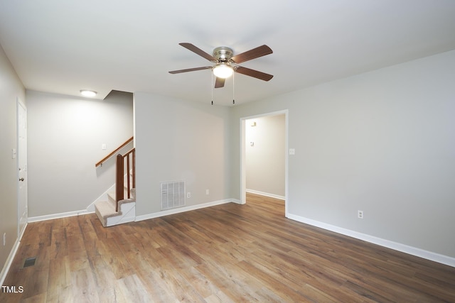 2012 Stadium Dr, Durham, NC 27705 - unfurnished room featuring stairway, ceiling fan, baseboards, and wood finished floors
