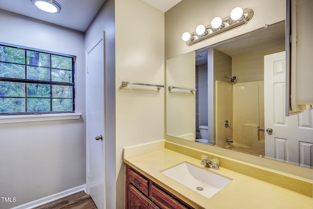 2012 Stadium Dr, Durham, NC 27705 - bathroom featuring vanity, wood finished floors, toilet, and baseboards