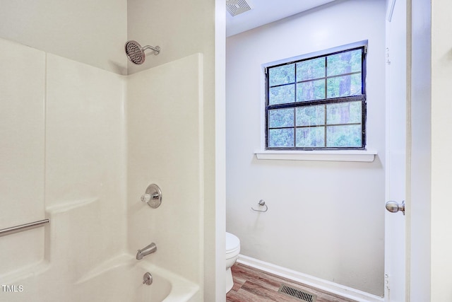 2012 Stadium Dr, Durham, NC 27705 - full bathroom featuring toilet, wood finished floors, washtub / shower combination, and baseboards