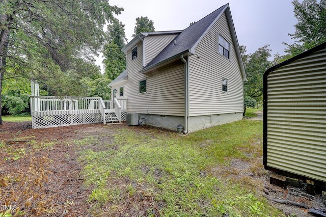 2012 Stadium Dr, Durham, NC 27705 - view of side of property featuring a wooden deck, central AC, and a lawn