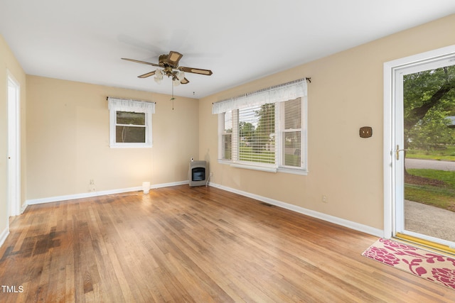 2015 Walnut St, Durham, NC 27705 - unfurnished living room with heating unit, plenty of natural light, light wood-style floors, and baseboards