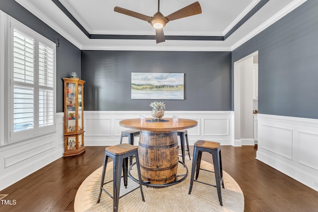 1716 Arberdour Dr, Apex, NC 27502 - dining room with dark wood-style flooring, a ceiling fan, a wainscoted wall, and crown molding